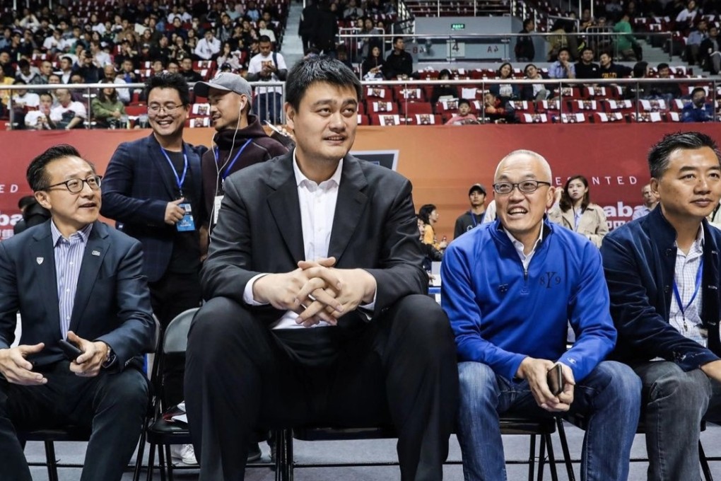 Yao Ming and Joe Tsai sit courtside for the Pac-12 China Game. Photos: Ali Sports