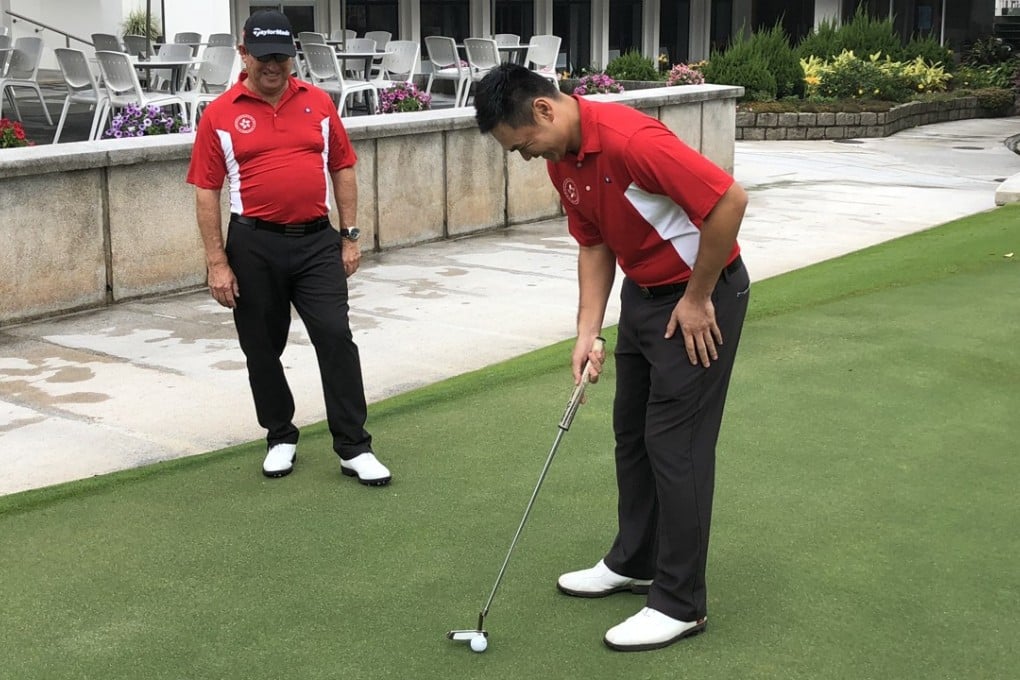 Gary Gilchrist gives Tim Tang putting tips. Photo: Sam Agars