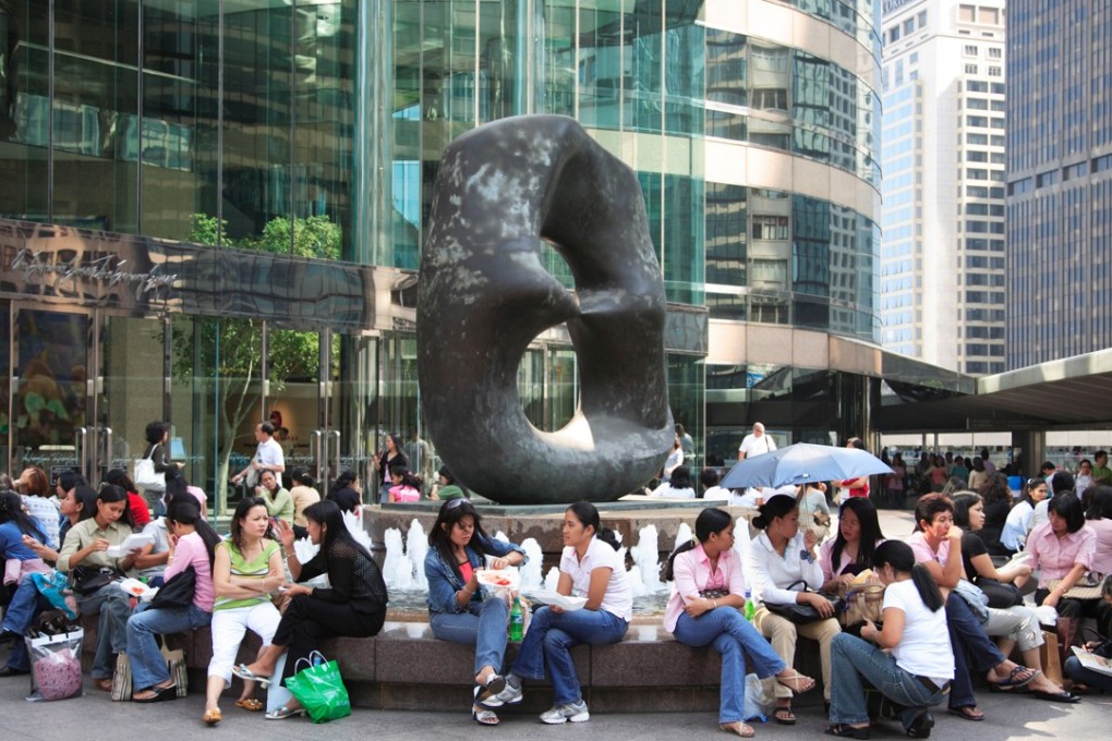 Domestic helpers from the Philippines on their off day in Central, Hong Kong. Photo: Alamy
