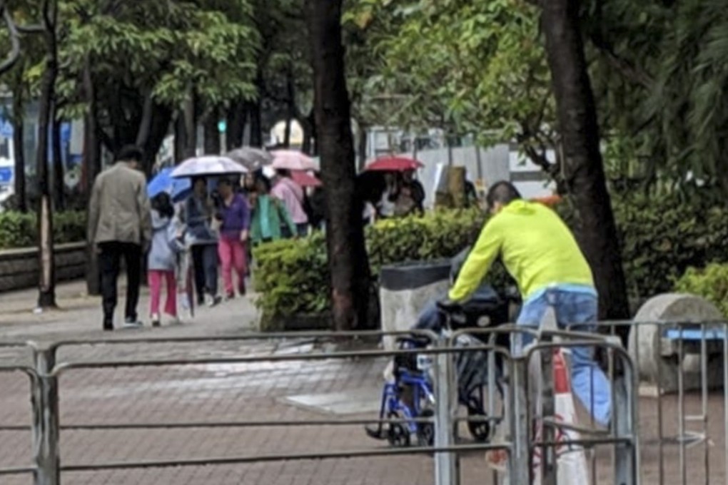 An elderly voter in Sham Shui Po is pushed to a nearby polling station by a pro-establishment volunteer. Photo: Sum Lok-kei
