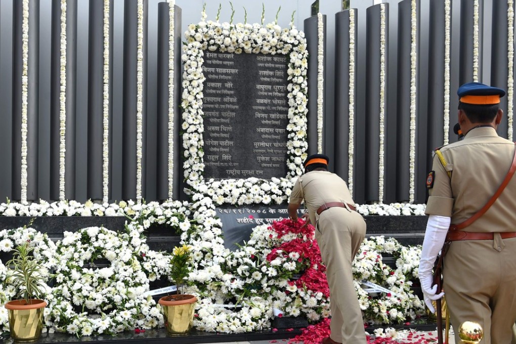 Members of the Mumbai police pay their respects at the Police Memorial on Monday. Photo: AFP
