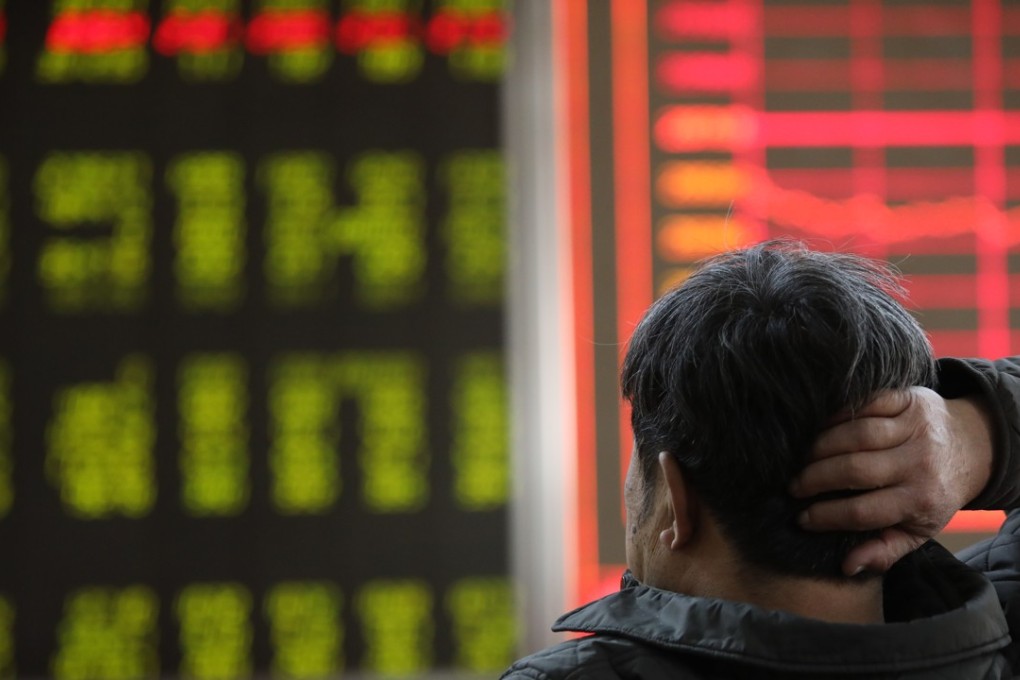 An investor looks on as prices fall at a stock brokerage house in Beijing. Photo: Simon Song