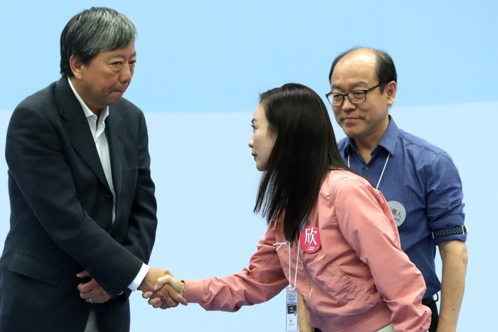 Defeated Lee Cheuk-yan shakes hands with by-election winner Rebecca Chan Hoi-yan as fellow loser Frederick Fung Kin-kee looks on. Photo: Sam Tsang