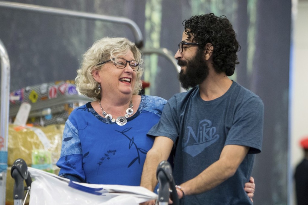 Hassan al-Kontar and a supporter from Canada share a light moment after his arrival in Vancouver. Photo: AP
