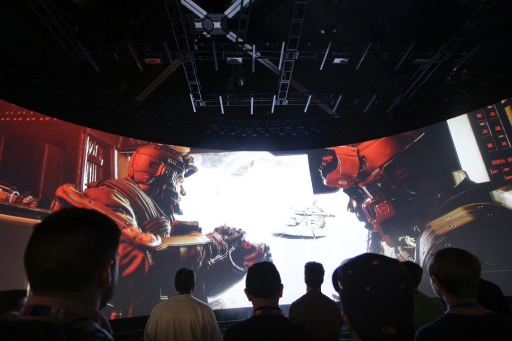 People watch the Call of Duty: Advanced Warfare video game trailer at the Activision booth at the Electronic Entertainment Expo, in Los Angeles. While most broadcasters freely stream themselves playing games, many influencers with millions of followers are now regularly sponsored or paid by game publishers. Photo: AP