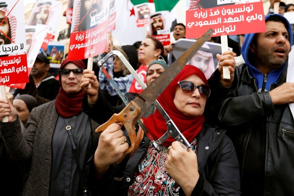 A woman holding two saws at a protest against the visit of Saudi Arabia’s Crown Prince Mohammed bin Salman to Tunisia, in Tunis on November 27, 2018. Photo: Reuters