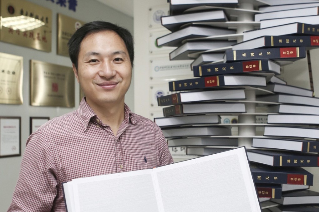 Scientist He Jiankui poses with ‘The Human Genome’, a book he edited. Photo: Handout