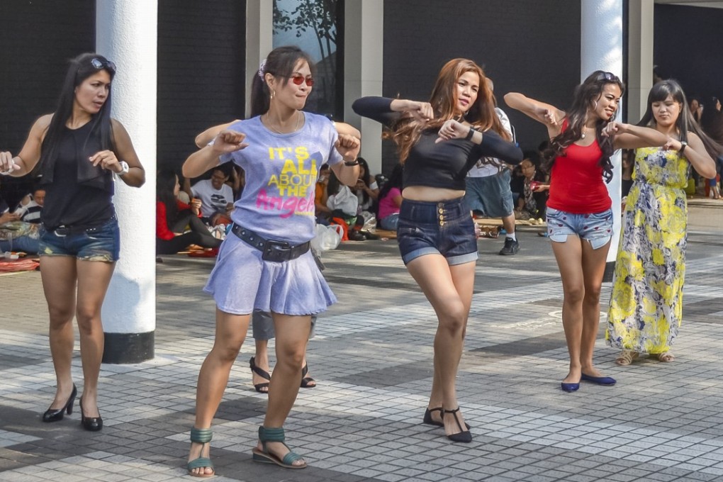 Filipino helpers in Hong Kong dance on a Sunday, their usual day off, in this photo taken in 2015. Photo: Imaginechina/Corbis