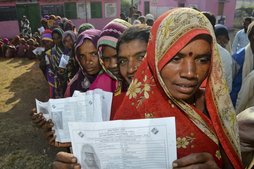India's ‘Gond’ tribal women display their voter slips as they wait in line to vote. Photo: AP