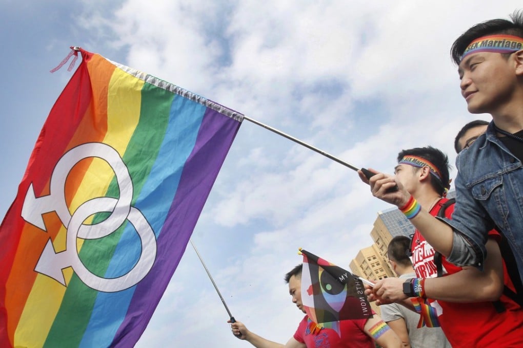 Supporters of same-sex marriage rights wave rainbow flags at a Taipei rally in 2016. However, Taiwanese voters blocked same-sex marriage laws in a November 24 referendum. Photo: AP