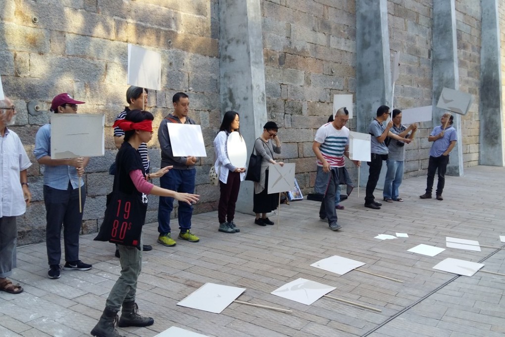 Wen Yau (front) performing a silent protest against eroding artistic freedom with other artists at the Tai Kwun arts venue in Hong Kong on November 18.