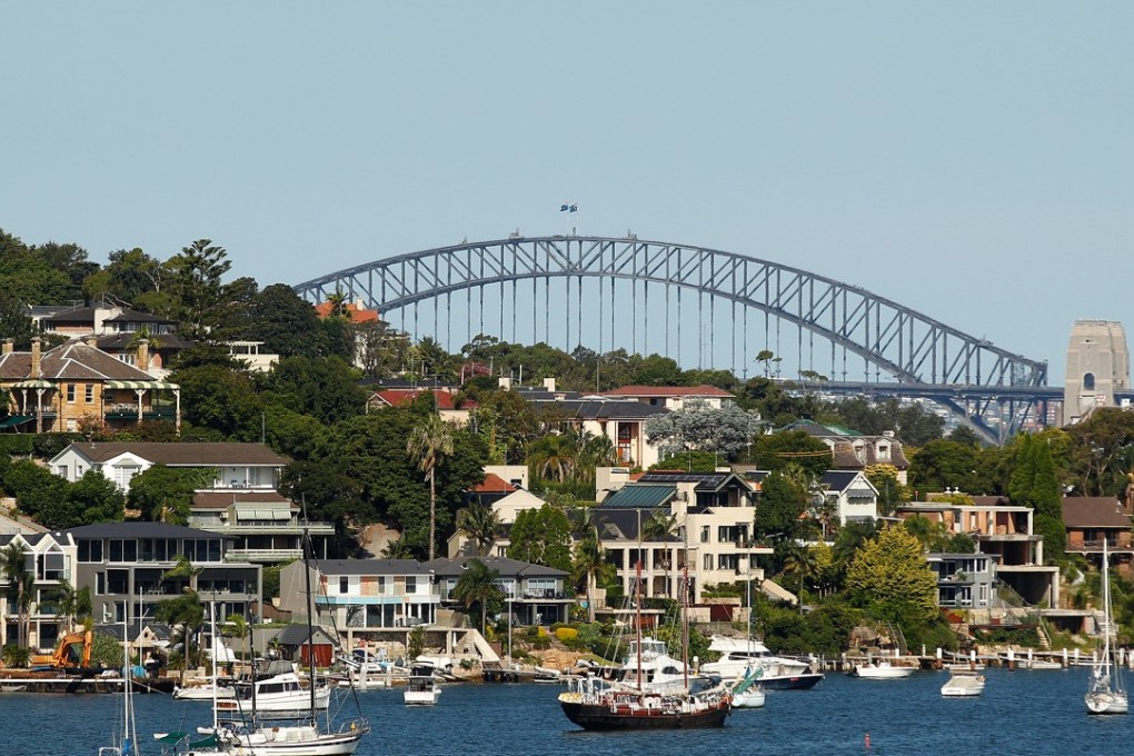 Waterfront homes in the suburb of Woolwich, with the Sydney Harbour Bridge in the distance on Wednesday, February 17, 2016. Photo: Bloomberg