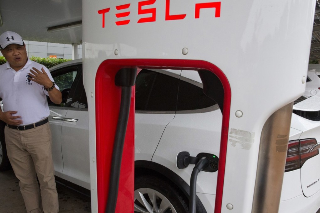 Tesla car owner Shan Junhua chats about privacy near his vehicle, while charging it in Shanghai. When Shan bought his Tesla Model X, he knew it was a fast, beautiful car. What he did not know is that Tesla constantly sends information about the precise location of his car to the Chinese government. Carmakers selling electric vehicles in China send a constant feed of information about the location of cars to the government. Photo: AP