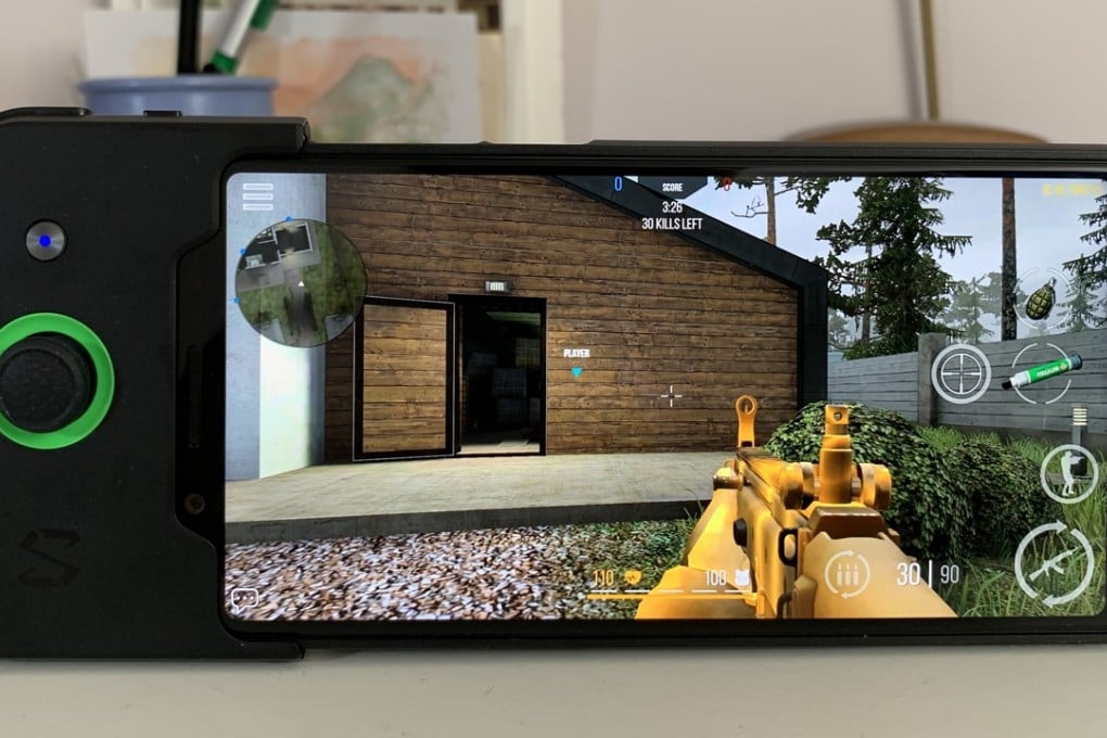 The Black Shark gaming phone by Xiaomi with the gamepad accessory attached improves the gaming experience, especially in games requiring precision aiming. Photo: Ben Sin