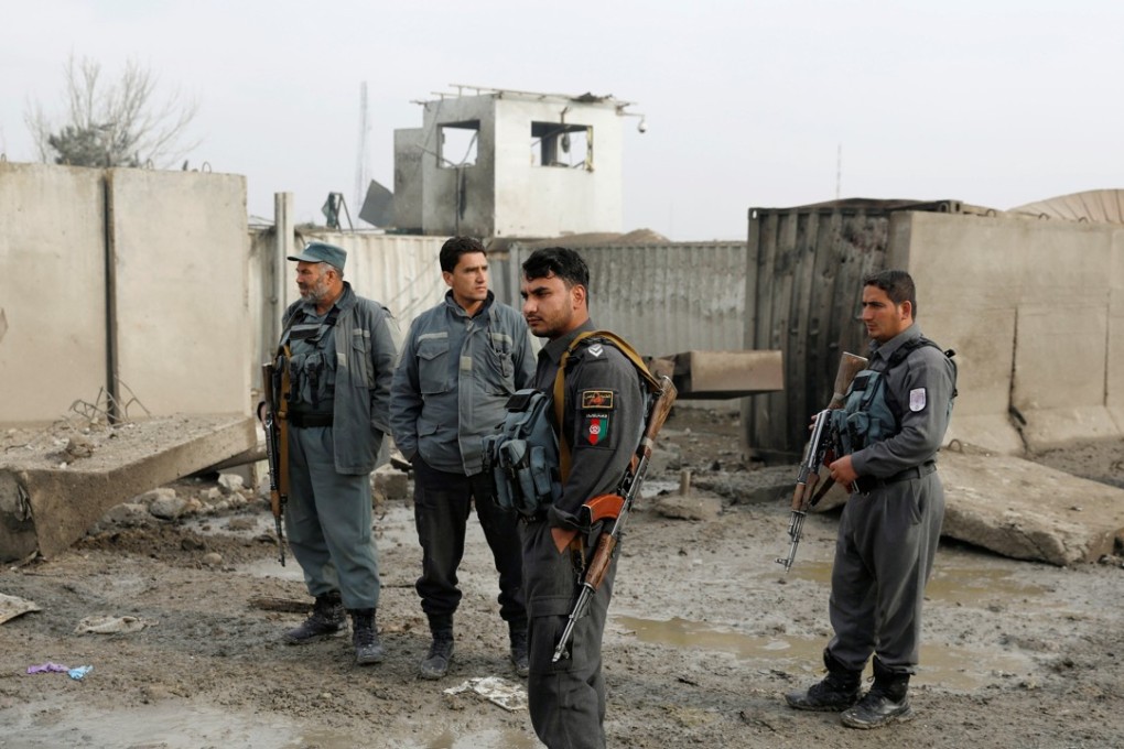 Afghan policemen stand guard at the site of a car-bomb attack in Kabul, Afghanistan, November 29, 2018. Photo: Reuters