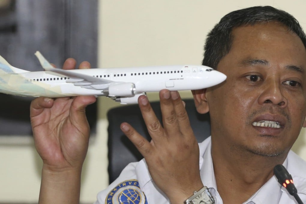 National Transportation Safety Committee investigator Nurcahyo Utomo holds a model of an aeroplane during a press conference on Wednesday. Photo: AP