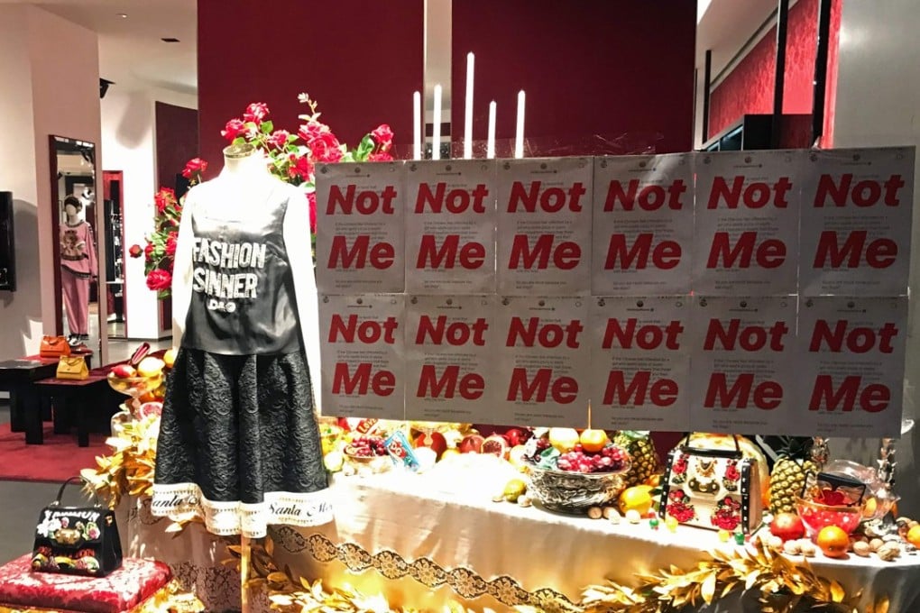 A protest banner on the window of a Dolce & Gabbana store in Shanghai. The founders of the Italian fashion house apologised to Chinese customers on November 23, as a row over racially offensive posts snowballed, with its products pulled from lucrative Chinese e-commerce platforms. Photo: AFP/Edward Gu