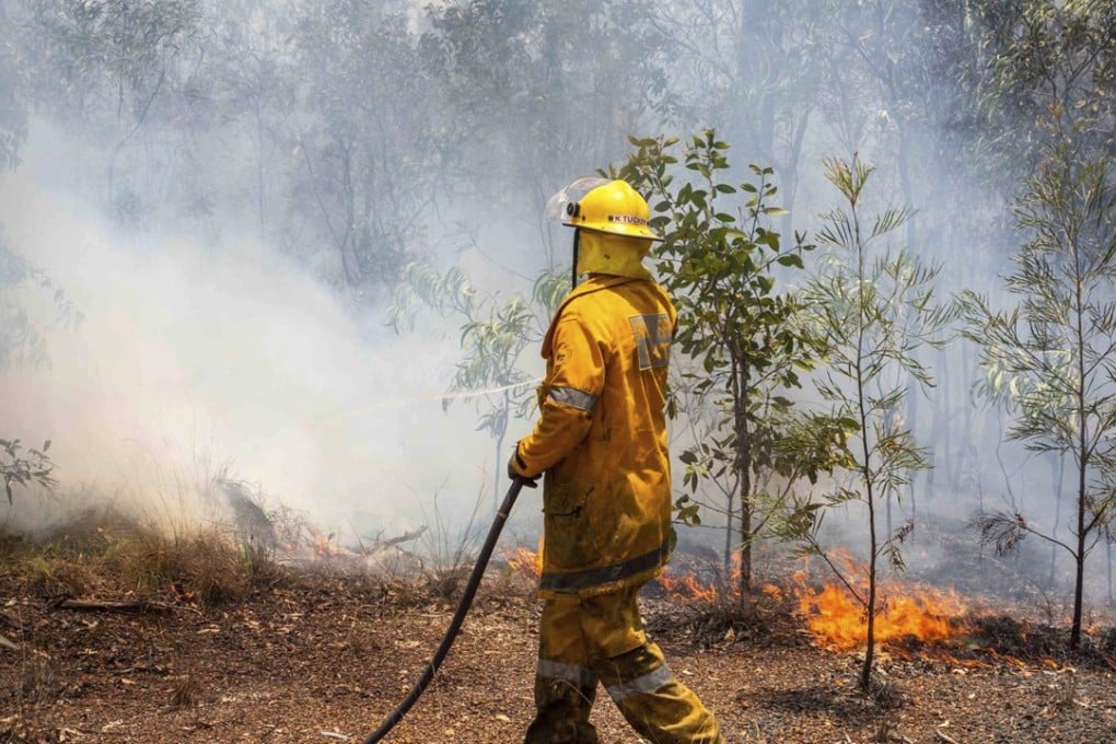 A firefighter works to put out a blaze in Queensland. Photo: AP