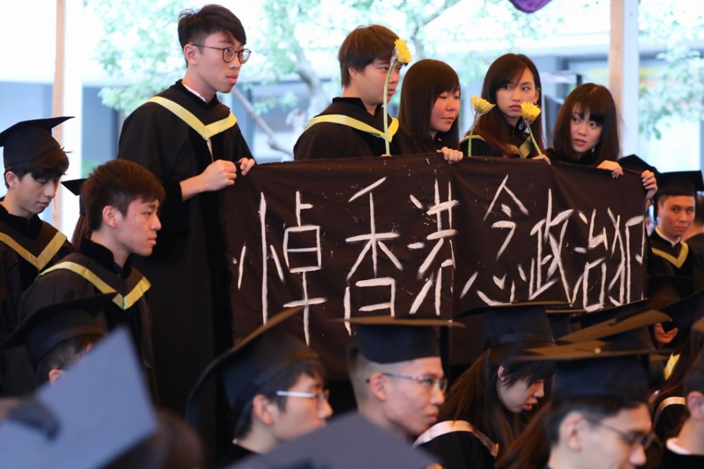 Students protest against the jailing of democracy activists, at the graduation ceremony of the Chinese University of Hong Kong on November 15. Photo: Felix Wong
