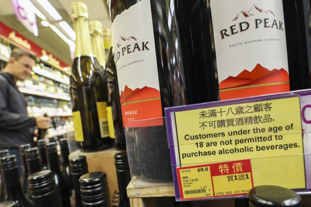 A sign warning of new restrictions on the sale of alcohol sits next to wine at a Wellcome supermarket in Causeway Bay. Photo: Dickson Lee