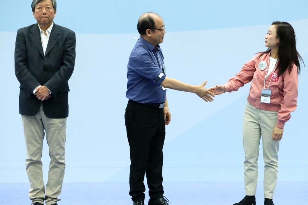 By-election candidate Lee Cheuk-yan faces the audience while Frederick Fung congratulates election winner Chan Hoi-yan at the Tiu Keng Leng Sports Centre in Tseung Kwan O after the Legislative Council Kowloon West by-election result was announced on November 26. Chan won with 106,457 votes. Photo: Sam Tsang