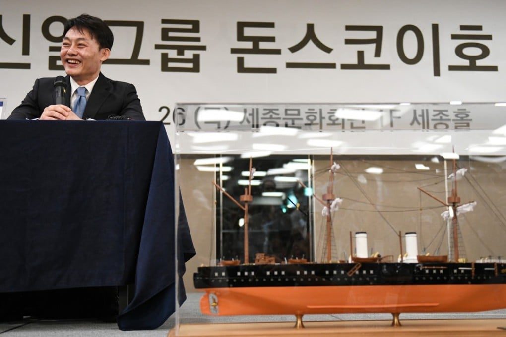 Choi Yong-seok, chief executive of Shinil Group, with a model of the Russian Navy’s Dmitrii Donskoi at a press conference on a “Russian treasure ship”, in Seoul, on July 26, 2018. Picture: AFP