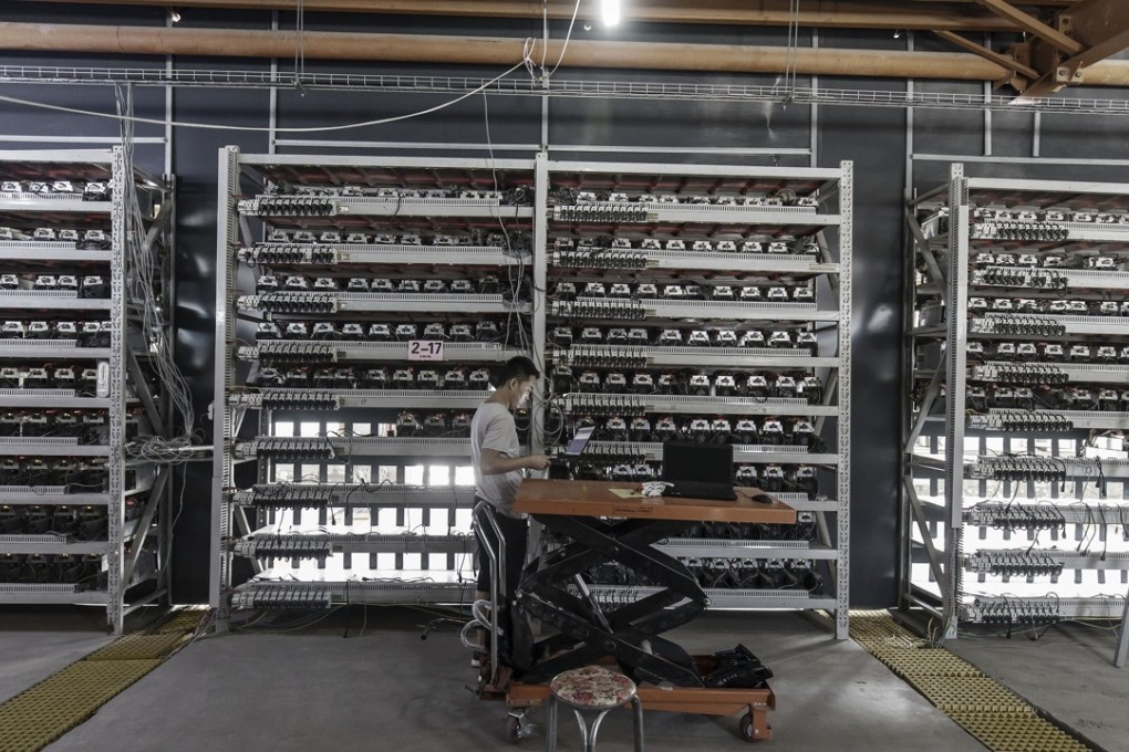 A technician inspects bitcoin mining machines at a Bitmain Technologies’ facility Inner Mongolia, China. Photo: Bloomberg