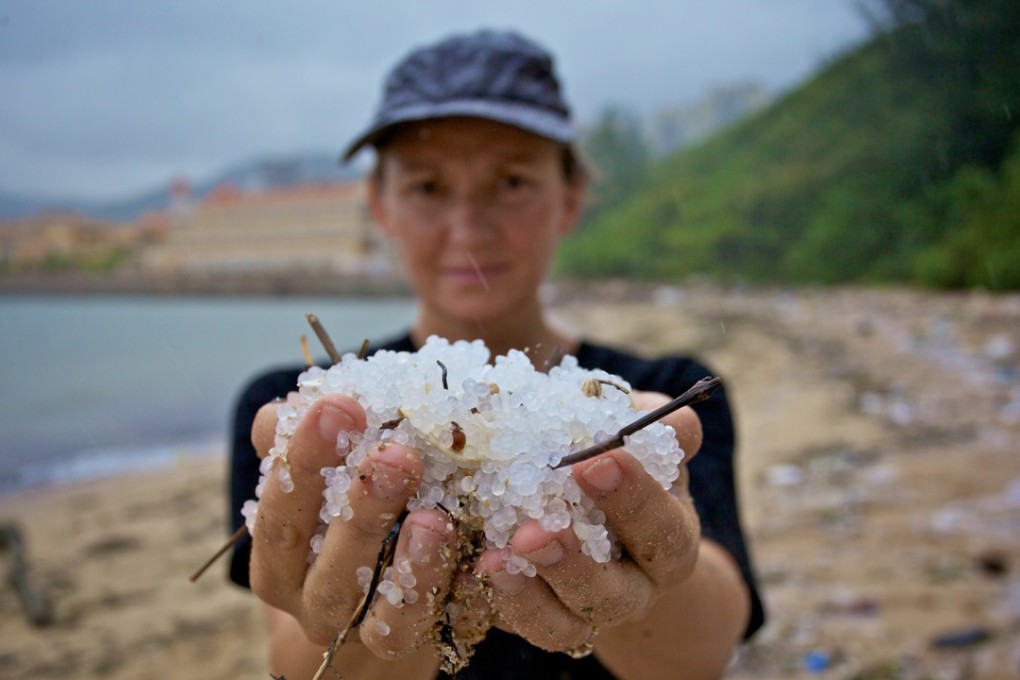 Tracey Read holds plastic pellets that washed ashore in Hong Kong in 2012. Picture: Gary Stokes