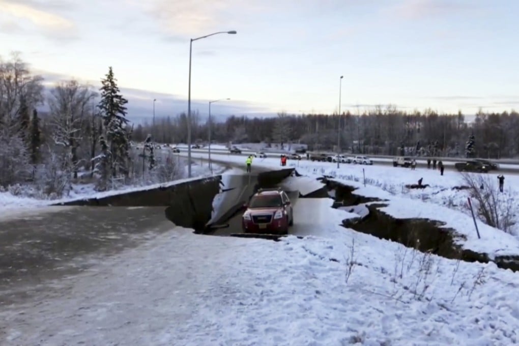 A car is trapped on a collapsed section of a road in Anchorage, Alaska, on Friday after two earthquakes hit the area. Photo: AP