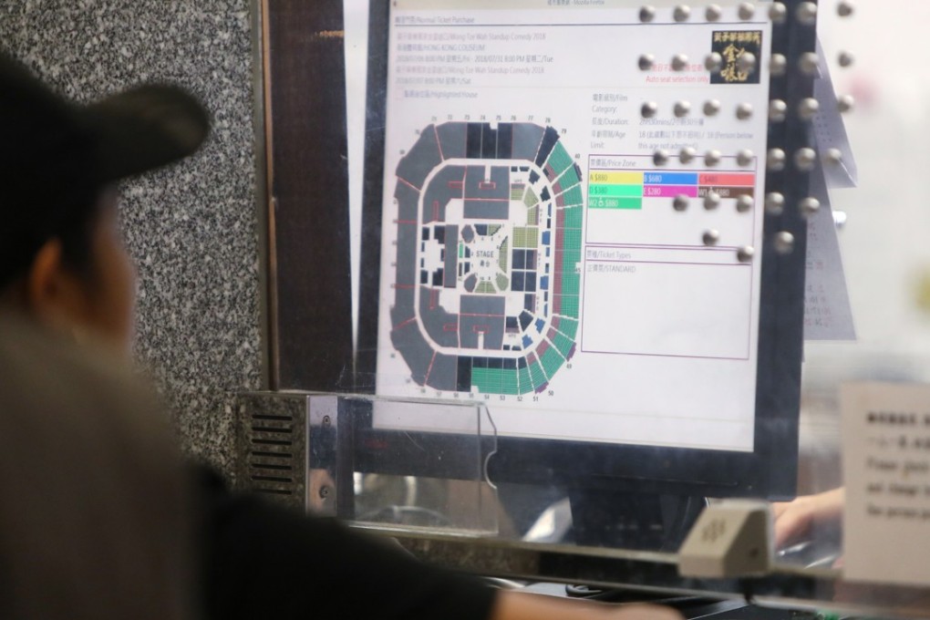 A fan chooses a seat for a stand-up comedy show at City Hall in Central. Photo: Winson Wong