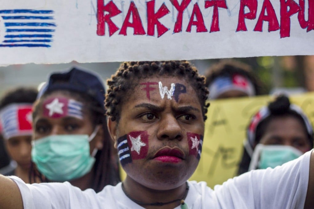 A Papuan student holds a banner which reads, 'Free Papuan People', at a rally in Surabaya, Indonesia. Photo: EPA