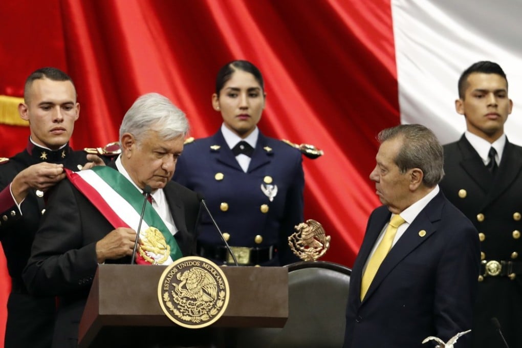 Mexico's new President Andres Manuel Lopez Obrador, left, receives the presidential sash as Porfirio Munoz Ledo, president of the Congress, right, looks on during the inaugural ceremony at the National Congress in Mexico City, Saturday, December 1, 2018. Photo: AP Photo/Eduardo Verdugo