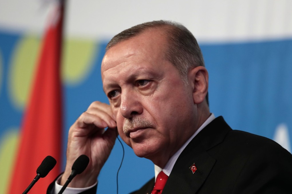 Turkey's President Recep Tayyip Erdogan, adjusts his earphone during his final press conference on the second day of the G20 Leader's Summit, in Buenos Aires, on December 01, 2018. Photo: AFP