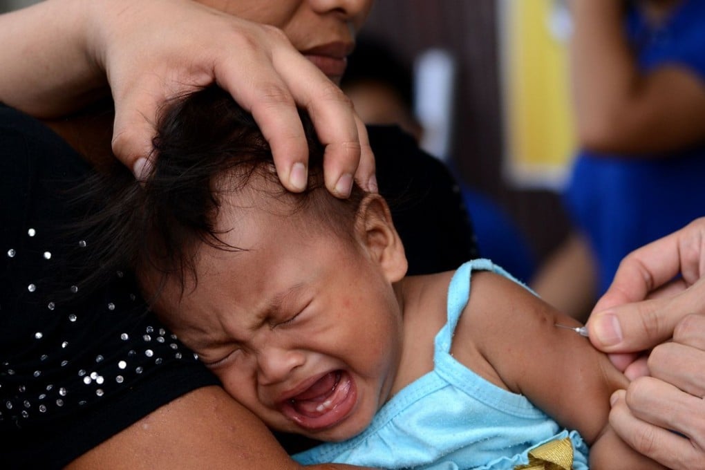 A file photo of a baby receiving a measles vaccine in Tacloban, Leyte province. Photo: AFP