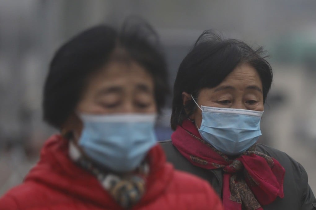 Chinese women wear masks during a polluted day in Beijing. According to a report by the UN, CO2 emissions have gone up for the first time in four years. Photo: EPA
