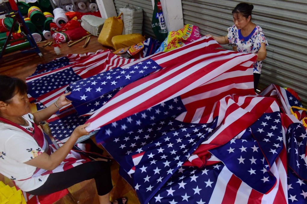 Chinese employees sew flags at a factory in Fuyang in eastern Anhui province, where trade with the US is an important component of business. Photo: AFP