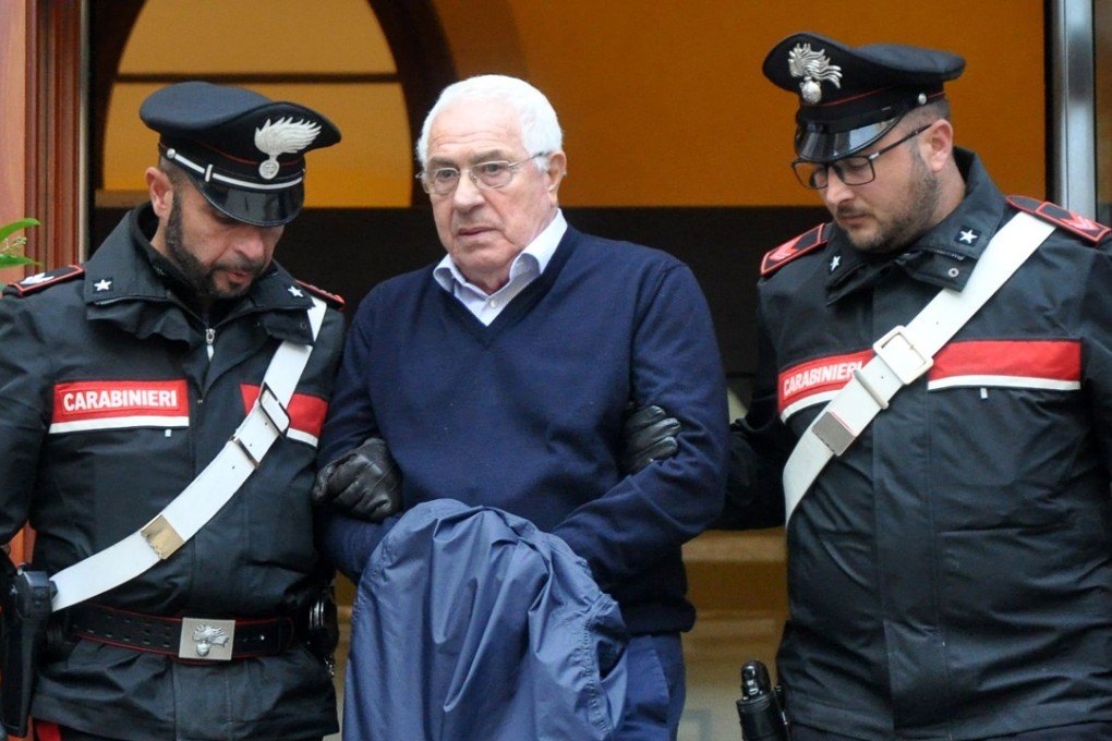 Settimino Mineo, jeweller and new head of the Sicilian mafia, is escorted by police after his arrest in Palermo on December 4, 2018. Photo: AFP