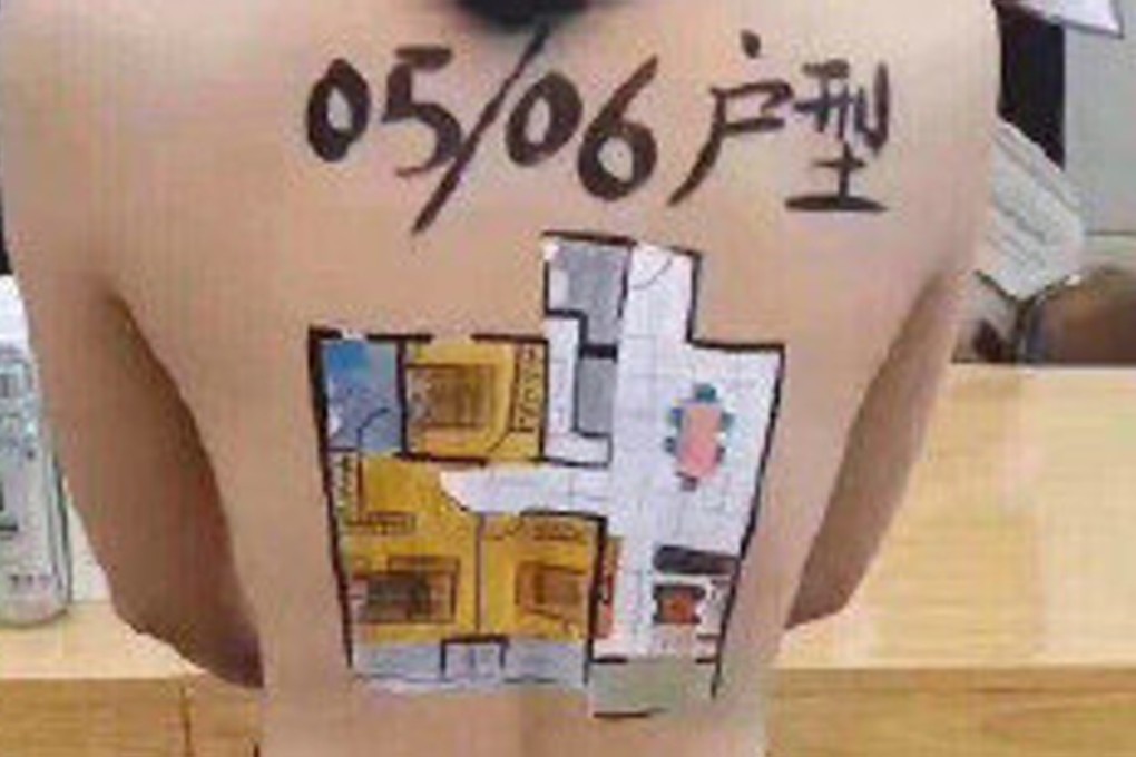 A property company in southwest China that ran into an internet controversy for painting advertising slogans and images on topless models was told on Monday that it could not sell its development because it did not have a licence to do so. Photo: Weibo