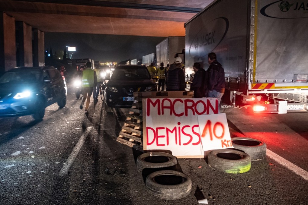 A sign that reads ‘Macron resignation’ on a barricade built by ‘yellow vests’ on a motorway in Narbonne, France on November 20, 2018. Photo: Bloomberg