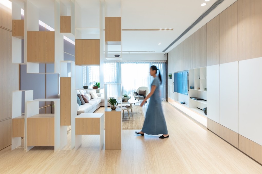 The living area of this Kowloon Tong flat by Max Lam Designs features a unique divider, which seemingly floats in the centre of the room, providing storage and helping to divide the space. Photography: Dick Liu