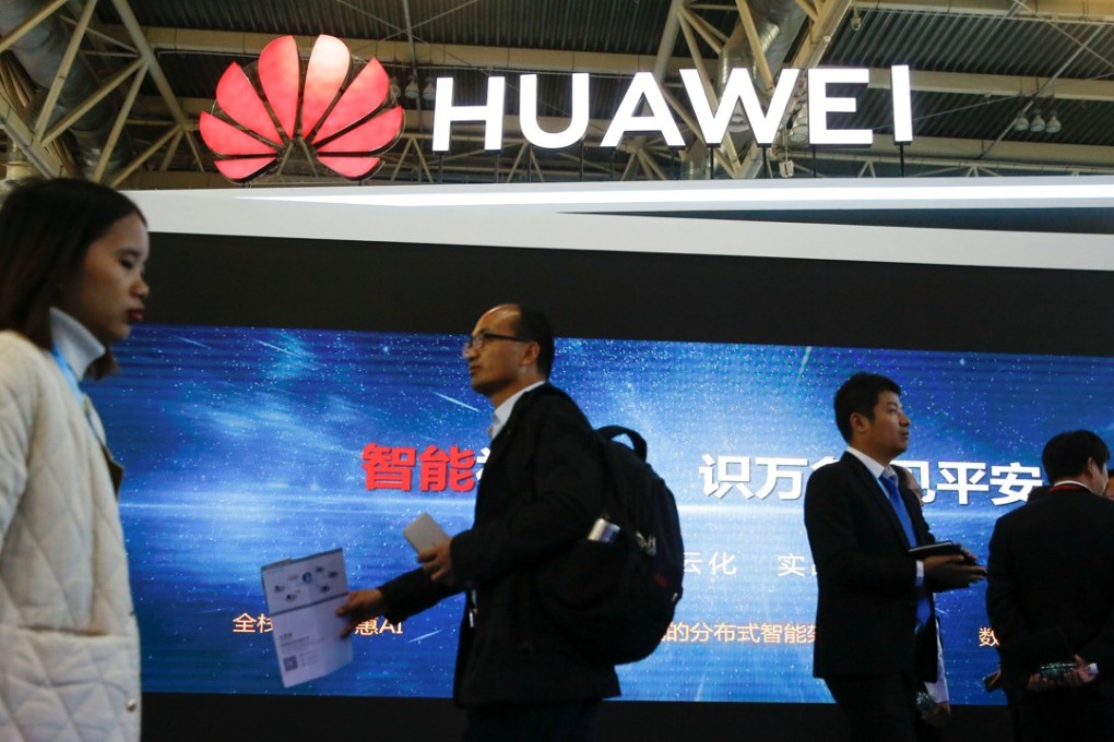 People walk past the stall of the telecoms equipment maker Huawei Technologies at the Security China 2018 exhibition on public safety and security in Beijing, 2018. Photo: Reuters