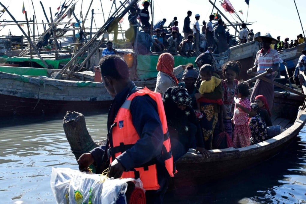 Myanmar navy personnel escort Rohingya Muslims back to their camp in Sittwe, Rakhine state. Photo: AFP