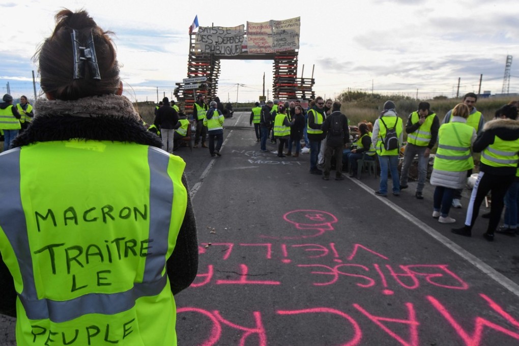 More than 300,000 people from across France have blocked roads and gas depots, defaced the Arc de Triomphe, burned cars and broken store windows over three weekends. Photo: AFP