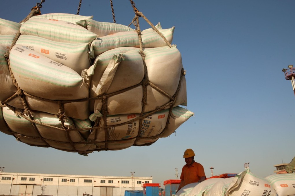 Workers move imported soybean products at a port in Nantong, Jiangsu province. The US and China have called a trade truce, with the Chinese agreeing to resume buying US agricultural products. Photo: Reuters