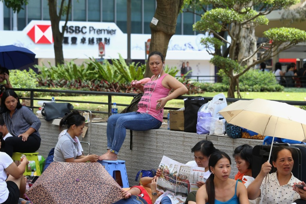 Domestic helpers spent their day off in Central in July. The lack of job opportunities in the Philippines has forced many women to come to Hong Kong for work. Photo: Dickson Lee