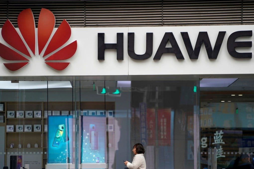 A woman walks by a Huawei logo at a shopping centre in Shanghai, China. Japan is set to ban all Chinese tech giants Huawei and ZTE from government contracts on Monday. Photo: Reuters