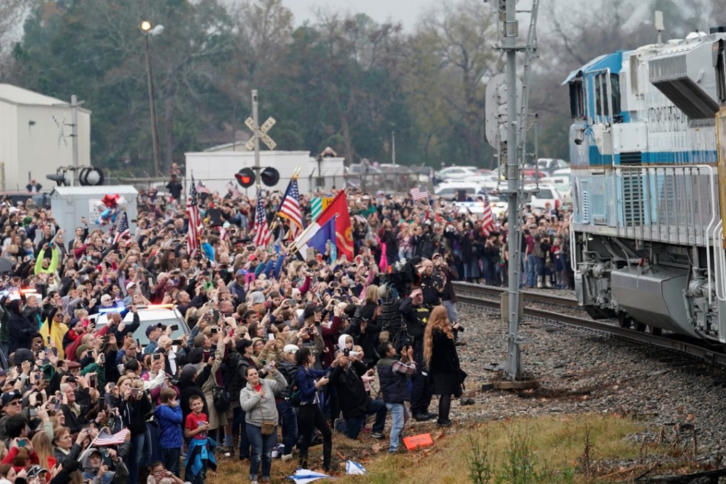 People pay their respects as the train carrying the casket of former US president George H.W. Bush passes on Thursday in Texas. Photo: Reuters