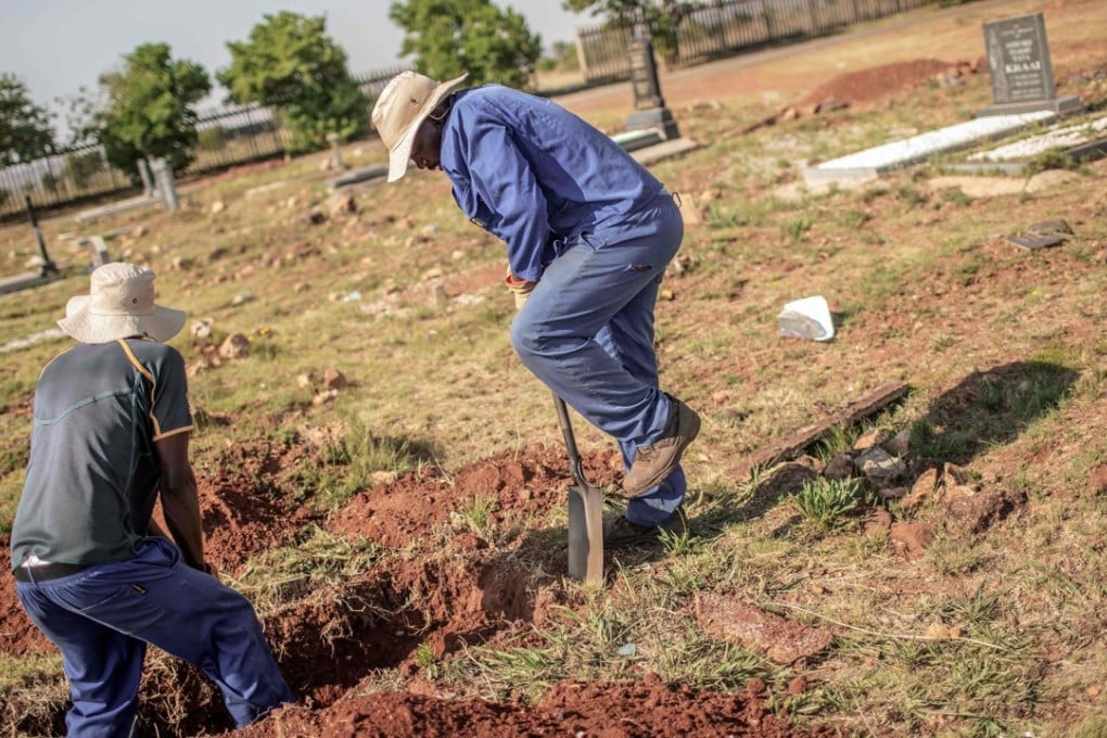 Workers digging a grave in the Avalon Cemetery in Soweto on November 15, 2018. Photo: AFP