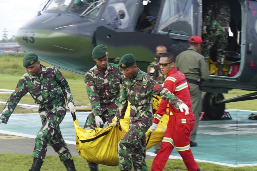 Indonesian soldiers carry a body bag containing a victim of the separatist attack in Nduga district. Photo: AP
