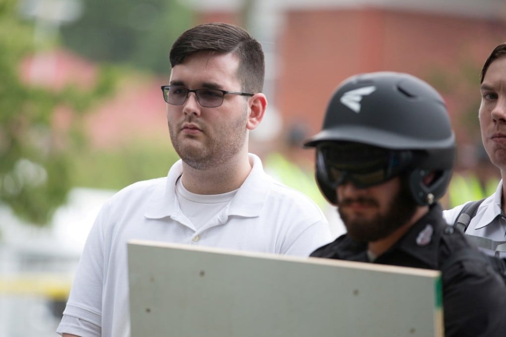 FILE PHOTO: James Alex Fields Jnr, (L) is seen attending the “Unite the Right” rally in Emancipation Park before being arrested by police and charged with charged with one count of second degree murder, three counts of malicious wounding and one count of failing to stop at an accident that resulted in a death after police say he drove a car into a crowd of counter-protesters later in the afternoon in Charlottesville, Virginia, US, August 12, 2017. REUTERS/Eze Amos/File Photo